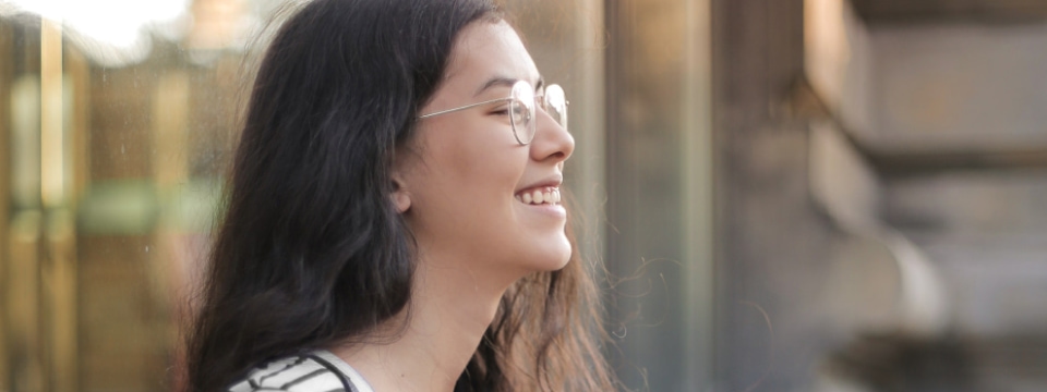 a person smiling with glasses